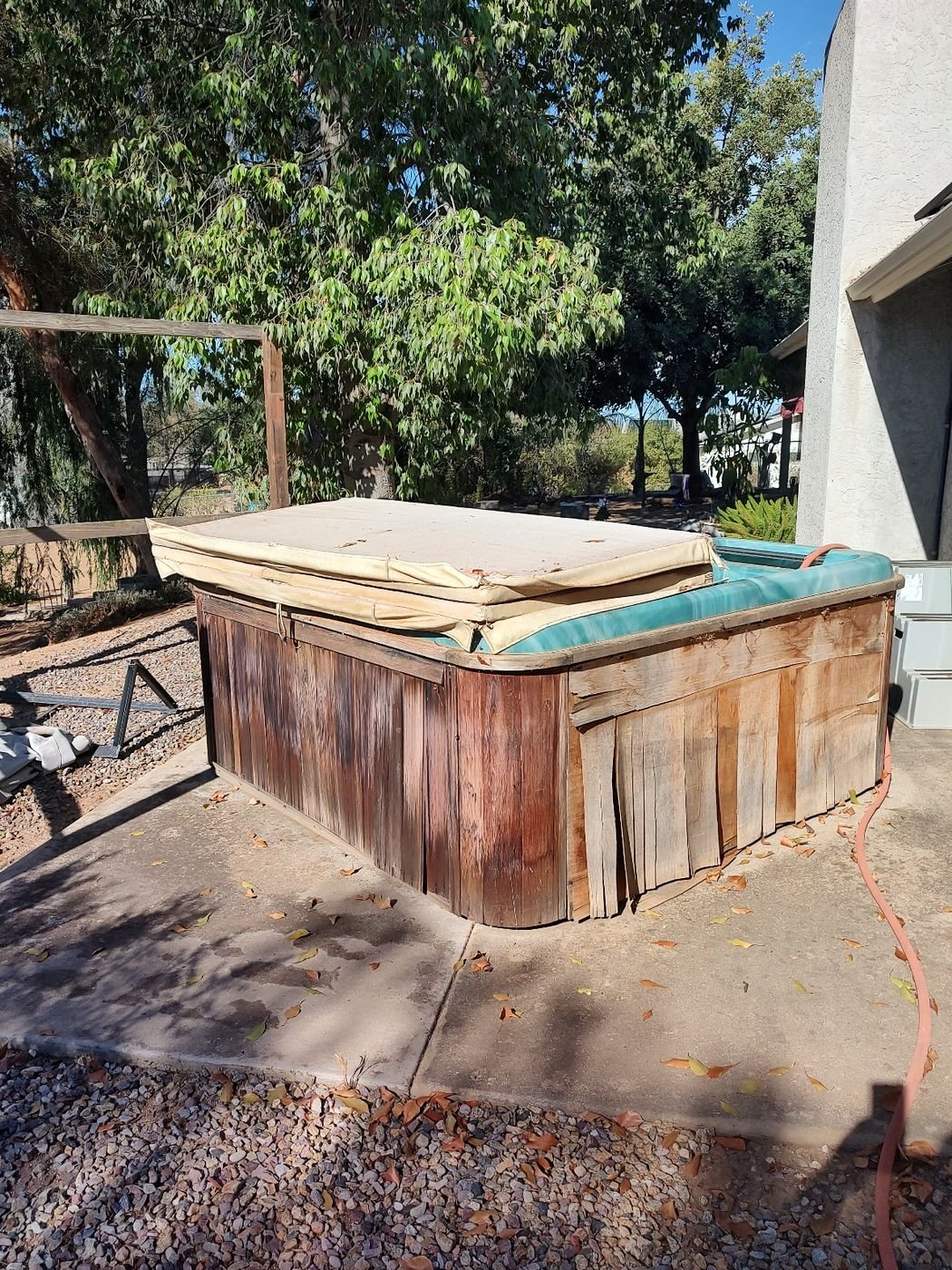 Worn wooden hot tub before removal